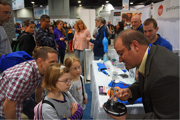 Dr. Mark Kimball explaining to young students how a heat engine works.